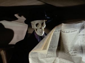 A skeleton in a businessman's coat